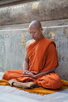India, Bihar, Bodhgaya, A Buddhist Monk in meditation at the Mahabodhi Temple in Bodhgaya.