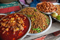 India, Bengal, Kolkata, Food stall at Malik Ghat Flower Market selling chickpeas, prawns and fish.
