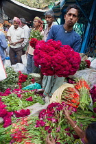 India, Bengal, Kolkata, Vendor in Malik Ghat Flower Market in Kolkata.