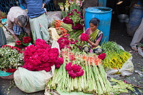 India, Bengal, Kolkata, Vendor in Malik Ghat Flower Market in Kolkata.