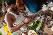 India, Bengal, Kolkata, Pan Vendor in Malik Ghat Flower Market, Kolkata.