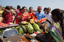 India, Tamil Nadu, Mahabalipuram, Water melon & pineapple vendor on the beach at Mahabalipuram.