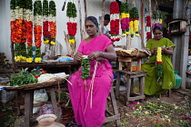 India, Andhra Pradesh, Tirupati, Flower vendors making garlands.