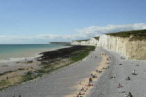 England, East Sussex, Birling Gap, View along pebble beach with the Seven Sisters white chalk cliffs.