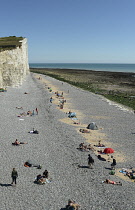 England, East Sussex, Birling Gap, View along pebble beach with the Seven Sisters white chalk cliffs.