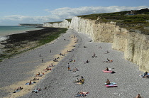 England, East Sussex, Birling Gap, View along pebble beach with the Seven Sisters white chalk cliffs.