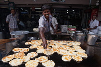 India, Tamil Nadu, Tiruchirappalli, Trichy, Man frying parathas at a food hotel in Tiruchirappalli, Trichy, .