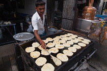 India, Tamil Nadu, Tiruchirappalli, Trichy, Man frying parathas at a food hotel in Tiruchirappalli, Trichy, .