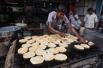 India, Tamil Nadu, Tiruchirappalli, Trichy, Man frying parathas at a food hotel in Tiruchirappalli, Trichy, .