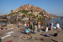 India, Karnataka, Hampi, Pilgrims bathe at the Tungabhadra River at Hampi.