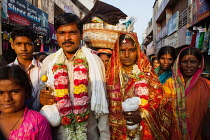 India, Karnataka, Hospet, Bride & groom with guests at a wedding in Hospet.