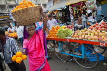 India, Karnataka, Mysore, Woman selling oranges at Devaraja Market in Mysore.