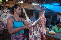 India, Kerala, Fort Cochi, Butcher in the market at Fort Cochi.