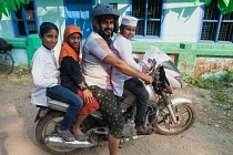 India, Kerala, Alleppey, A muslim family on a motorbike.