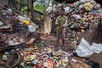 India, Kerala, Varkala, Portrait of a labourer at a recycling plant in Varkala.