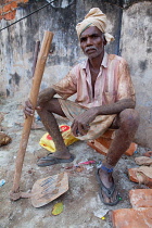 India, Kerala, Anjengo, Portrait of a road labourer in the town of Anjengo.