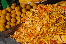 India, Karnataka, Bijapur, Display of chana choor, Bombay mix, & laddoos, to the left, in the market at Bijapur.