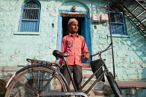 India, Karnataka, Bijapur, Portrait of a muslim boy with a bicycle.