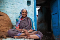 India, Karnataka, Bijapur, Portrait of an elderly woman in front of her home in the old town of Bijapur.
