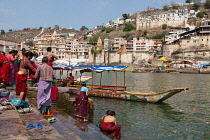 India, Madhya Pradesh, Omkareshwar, Pilgrims on the ghats beside the Narmada River at Omkareshwar.