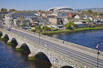 Ireland, County Limerick, Limerick City, Thomond Park Rugby Football ground seen from St Johns Castle with the River Shannon in the foreground.