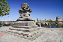 Ireland, County Limerick, Limerick City, The Treaty Stone with the River Shannon and St John's Castle.