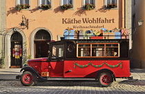 Germany, Bavaria, Rothenburg ob der Tauber, Kathe Wohlfahrt Christmas shop with present laden truck outside.