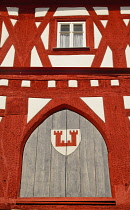 Germany, Bavaria, Rothenburg ob der Tauber, Shapes and Patterns on a half timbered house in Marktplatz with the towns coat of arms.