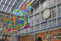 England, London, St Pancras railway station on Euston Road, the terminal clock with The Meeting Place statue by Paul Day.