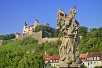 Germany, Bavaria, Wurzburg, Festung Marienberg above the River Main with a statue of St Marie or Mary Patron saint of Franconia.