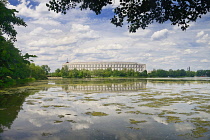 Germany, Bavaria, Nuremberg, Nazi Party Rally Grounds, Kongresshalle or Congress Hall with Dutzendteich Lake in the foreground.