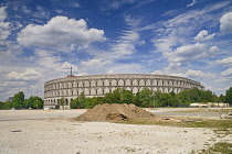 Germany, Bavaria, Nuremberg, Nazi Party Rally Grounds, Kongresshalle or Congress Hall with wasteland in the foreground.