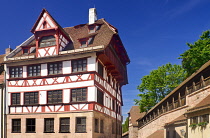 Germany, Bavaria, Nuremberg, Albrecht Durer Haus, Home of the German Renaissance artist with city ramparts behind.