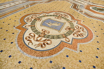 Italy, Lombardy, Milan. Galleria Vittorio Emanuele, Famous bull mosaic on the floor where tradition says that if a person spins around three times with a heel on the testicles of the bull on the Turin...