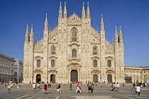 Italy, Lombardy, Milan. Milan Duomo or Cathedral, General view of the facade with tourists in the piazza out front.