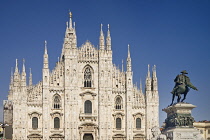 Italy, Lombardy, Milan. Milan Duomo or Cathedral, A section of the facade with the statue of King Victor Emmanuel II on horseback out front.