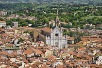 Italy, Tuscany, Florence, The 19th century marble facade of the 13th century Gothic church of Santa Croce containing the tombs of famous Florentines such as Michelangelo and Galilieo, View from the be...