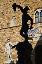 Italy, Tuscany, Florence, Piazza della Signoria, Replica of the famous David statue by Michelangelo with silhouette of the Perseus statue.