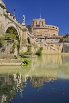 Italy, Rome, Castel Sant Angelo from along the banks of the River Tiber under the Pont Sant Angelo.