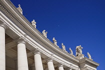 Italy, Vatican City, Statues on the sweeping colonnade by Bernini that circles Piazza San Pietro or St Peters Square.
