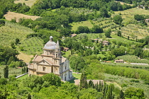 Italy, Tuscany, Montepulciano, Tempio di San Biagio Church. High Renaissance church with domed roof surrounded by lush green trees and olive groves.