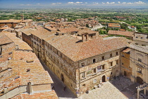 Italy, Tuscany, Montepulciano, View over the rooftops of the town towards distant hills from the tower of Palazzo Comunale or Town Hall.