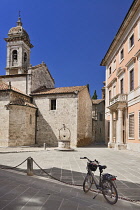 Italy, Tuscany, Val D'Orcia, San Quirico D'Orcia, The rear of the Collegiate Church of San Quirico D'Orcia or Collegiata dei Santi Quirico e Giulitta with Palazzo Chigi to the right.