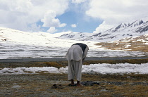 Pakistan, Religion, Islamic, Muslim praying on the snow covered border between Pakistan Afghanistan and China.