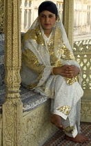 India, Kashimir, Religion, Woman wearing a white and gold engagement dress.