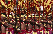 Sri Lanka, Kandy, Celebration parade for J.R Jayewardene with men in red and yellow costumes carrying flags.