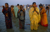 India, West Bengal, Ganga Sagar, Pilgrims bathing and praying in water during three day festival at Sagar Island in the mouth of the Hooghly thought to be the point where the Ganges joins the sea.