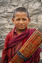 India, Ladakh, Leh, Head and shoulders portrait of novice monk.