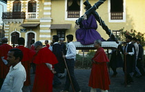 India, Goa, Margao, Easter procession. Men carrying statue of Christ at calvary through street.