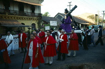 India, Goa, Margao, Men carrying statue of Christ at calvary past the Holy Spirit Nursing Home during Easter procession.